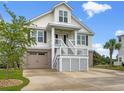 Inviting two-story home featuring a charming front porch and a two-car garage at 489 Harbour View Dr., Myrtle Beach, SC 29579