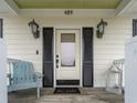 Close-up of the cozy front porch with seating and stylish decor at 489 Harbour View Dr., Myrtle Beach, SC 29579