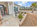 Inviting front porch with rocking chairs and landscaping, creating a cozy outdoor space at 500 Canborough Lane, Murrells Inlet, SC 29576