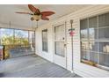 Cozy front porch with a porch swing and a ceiling fan, perfect for relaxing outdoors at 5092 Harrelson Ave., Loris, SC 29569