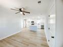 Open concept kitchen with island, white cabinets, modern stainless steel appliances and a large window at 530 Yarboro St., Mullins, SC 29574