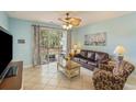 Bright living room with tile floors, ceiling fan, and sliding glass doors to the patio at 5801 Oyster Catcher Dr. # 1614, North Myrtle Beach, SC 29582
