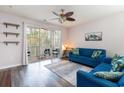 Living room features a blue sofa and access to a screened-in porch at 5801 Oyster Catcher Dr. # 724, North Myrtle Beach, SC 29582