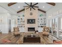 Bright living area boasts built-in shelves, accent chairs, and a decorative fireplace with mounted television at 6892 Belancino Blvd., Myrtle Beach, SC 29572
