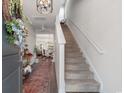 Bright foyer featuring staircase, wood floors, and a view of the dining area at 706 Gryffindor Dr., Little River, SC 29566