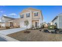 Well-kept front exterior with a two-car garage, manicured lawn, and charming landscaping at 706 Gryffindor Dr., Little River, SC 29566