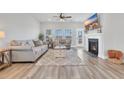 Bright living room with fireplace, large windows, neutral decor, and contemporary furnishings at 738 Harrison Mill St., Myrtle Beach, SC 29579