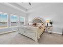 Serene main bedroom with plush carpet, a decorative headboard, and bright windows offering views at 738 Harrison Mill St., Myrtle Beach, SC 29579