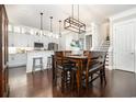 Bright kitchen and dining area with white cabinets, wood floors, and stylish lighting at 768 Satterwhite Way, Myrtle Beach, SC 29577