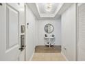 Stylish condo entryway features wood-look flooring, shiplap wall, and coastal-themed decor at 8560 Queensway Blvd. # 1206, Myrtle Beach, SC 29572
