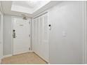Condo hallway with a neutral color palette, tile flooring, closet doors, and ceiling light at 8560 Queensway Blvd. # 1206, Myrtle Beach, SC 29572