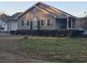 Beautiful single-story home featuring a well-kept lawn, inviting front porch, and attached garage at 9903 Conifer Ln., Murrells Inlet, SC 29576