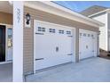 Attached white two car garage with stylish black hardware and ample parking at 1071 Laconic Dr., Myrtle Beach, SC 29588