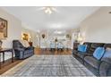 Spacious living room with hardwood floors, plush sofas, ceiling fan, and open to the dining area at 1100 Commons Blvd. # 1001, Myrtle Beach, SC 29572