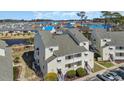Serene condo complex with lush landscaping, private balconies, and scenic views at 1100 Possum Trot Rd. # C202, North Myrtle Beach, SC 29582