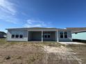 Back view of the house with patio and multiple windows at 1105 Oxeye St., North Myrtle Beach, SC 29582