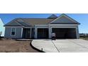 Attractive one-story home with gray siding and spacious two-car garage at 1105 Oxeye St., North Myrtle Beach, SC 29582