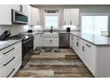 Modern kitchen featuring white cabinets, granite countertops, and stainless steel appliances at 113-B 10Th Ave. S, Surfside Beach, SC 29575