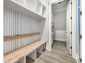 Well-designed mudroom with built-in bench, shelving, and stylish wood-look flooring at 1217 Bentcreek Ln., Myrtle Beach, SC 29579