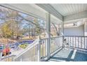 Balcony view with white railing overlooks a quiet, tree-lined street with lovely landscaping at 1221 Tidewater Dr. # 1721, North Myrtle Beach, SC 29582