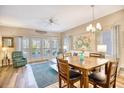 Bright living room with a dining table, hardwood floors, and access to the outdoor balcony at 1221 Tidewater Dr. # 1721, North Myrtle Beach, SC 29582