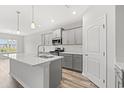 Stylish kitchen with stainless appliances, quartz countertops, and a modern kitchen island at 1227 Cypress Shoal Dr., Conway, SC 29526