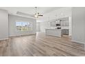 Open-concept living space featuring hardwood floors and large windows offering natural light at 1227 Cypress Shoal Dr., Conway, SC 29526