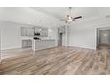 Bright living area open to the kitchen, complete with hardwood floors and modern lighting at 1227 Cypress Shoal Dr., Conway, SC 29526