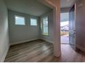 Inviting entryway with hardwood floors and two windows; front door open at 1229 Lady Bird Way, North Myrtle Beach, SC 29582