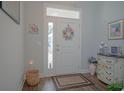 Bright entryway with wood-look floors, a decorative wreath, and stylish accent furniture at 148 Splendor Circle, Murrells Inlet, SC 29576