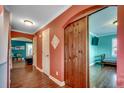 Hallway showcases hardwood floors, coral walls, arched openings, and a rustic sliding barn door at 1551 Victoria Ln., Myrtle Beach, SC 29577