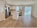 Modern kitchen features an island, stainless appliances, and sliding glass doors at 157 B Villa Grande St. # B, Myrtle Beach, SC 29579