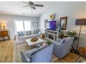 Inviting living room with a cozy fireplace, comfortable seating, and light wood flooring at 217 Sienna Dr., Little River, SC 29566