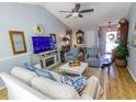 Bright living room featuring a fireplace, comfortable seating, and open access to the entryway at 217 Sienna Dr., Little River, SC 29566