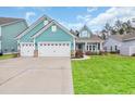 Charming single Gathering home with a three car garage, pristine landscaping, and a cozy front porch at 2418 Goldfinch Dr., Myrtle Beach, SC 29577