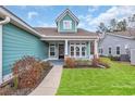 Charming front porch with colorful landscaping at 2418 Goldfinch Dr., Myrtle Beach, SC 29577