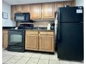Kitchen features black appliances, granite countertops, and wood cabinets with tiled backsplash at 2710 N Ocean Blvd. # 1038, Myrtle Beach, SC 29577