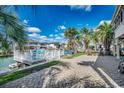 Waterfront backyard featuring a brick patio, lush palm trees, and serene views of the canal at 321 52Nd Ave. N, North Myrtle Beach, SC 29582