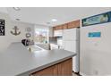 A bright kitchen features classic white appliances, wood cabinets and ample counter space at 351 Lake Arrowhead Rd. # 12-347, Myrtle Beach, SC 29572