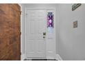 Front door with decorative window and secure lock features, blending style with practicality at 3700 Golf Colony Lane # 18-I, Little River, SC 29566