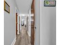 Bright hallway with wood floors and neutral walls, creating an open and airy atmosphere at 3700 Golf Colony Lane # 18-I, Little River, SC 29566