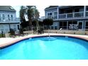 Inviting community pool with lounge chairs, tables and a relaxing spot to unwind at 3700 Golf Colony Lane # 18-I, Little River, SC 29566