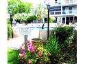 Beautiful community pool area surrounded by lush landscaping and inviting amenities at 3700 Golf Colony Lane # 18-I, Little River, SC 29566