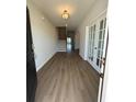 Bright foyer with wood-look floors, staircase, and glass french doors at 4008 Bucolic Loop, Myrtle Beach, SC 29588