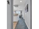 Hallway view showing the kitchen, living area, and access to outdoor balcony at 4413 Eastport Blvd. # F-1, Little River, SC 29566