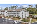 An exterior view shows a condo complex with balconies, landscaping, and parking at 4430 Eastport Blvd. # L5, Little River, SC 29566