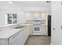 Bright kitchen features tile backsplash, white appliances, and plenty of counter space at 4430 Eastport Blvd. # L5, Little River, SC 29566