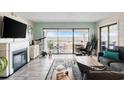 Comfortable living room featuring a fireplace and access to a scenic balcony with marina views at 4440 Nassau Ct. # 502, Little River, SC 29566
