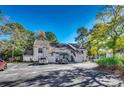 Condo complex showcasing mature trees and exterior details at 4466 Little River Inn Ln. # 906, Little River, SC 29566