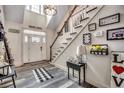Inviting foyer with a white door, staircase, decor, and light hardwood flooring creating a warm, welcoming entrance at 451 Holly View Ln., Loris, SC 29569